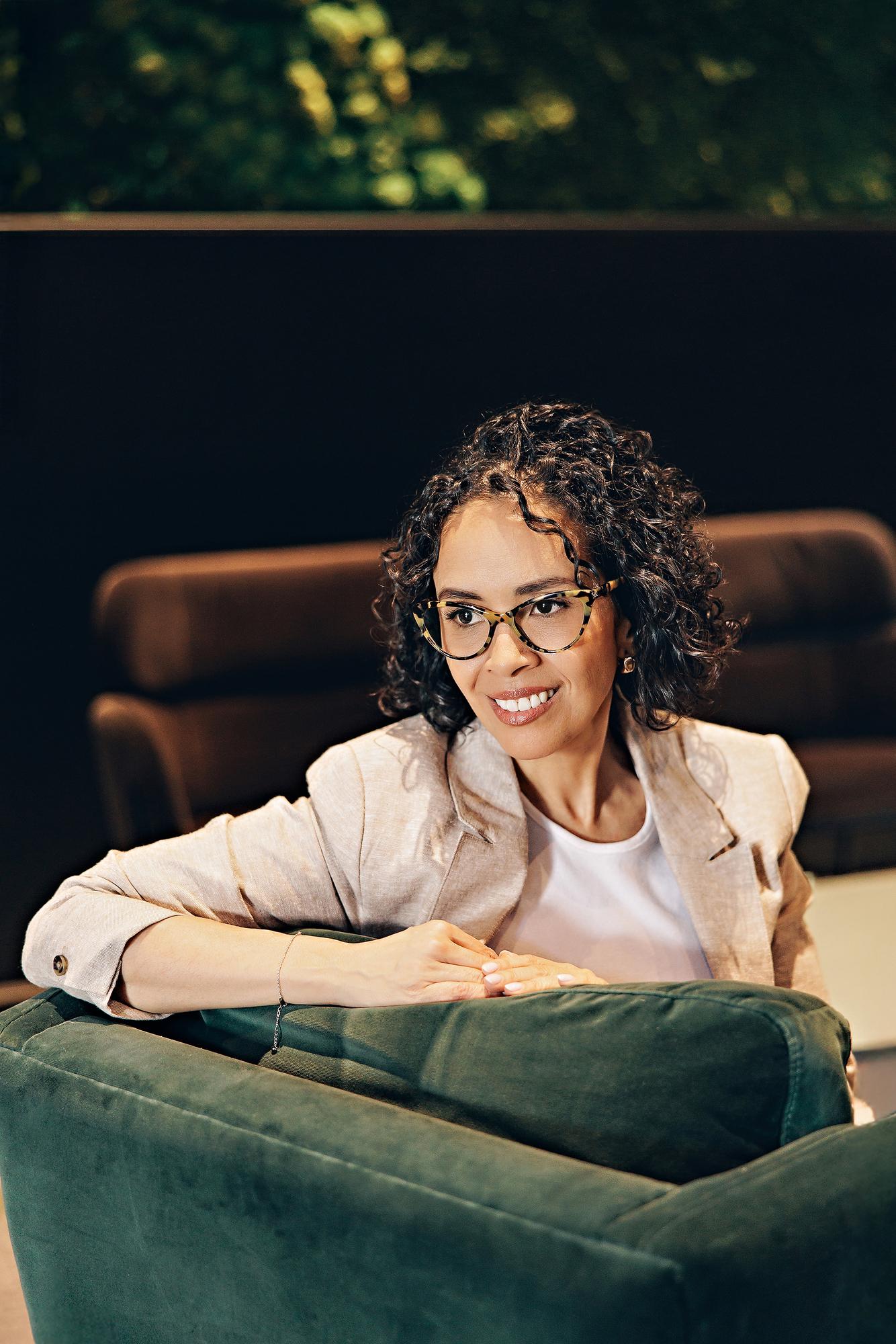 Creative personal branding Calgary: Thoughtful female entrepreneur looking away in a modern office lounge