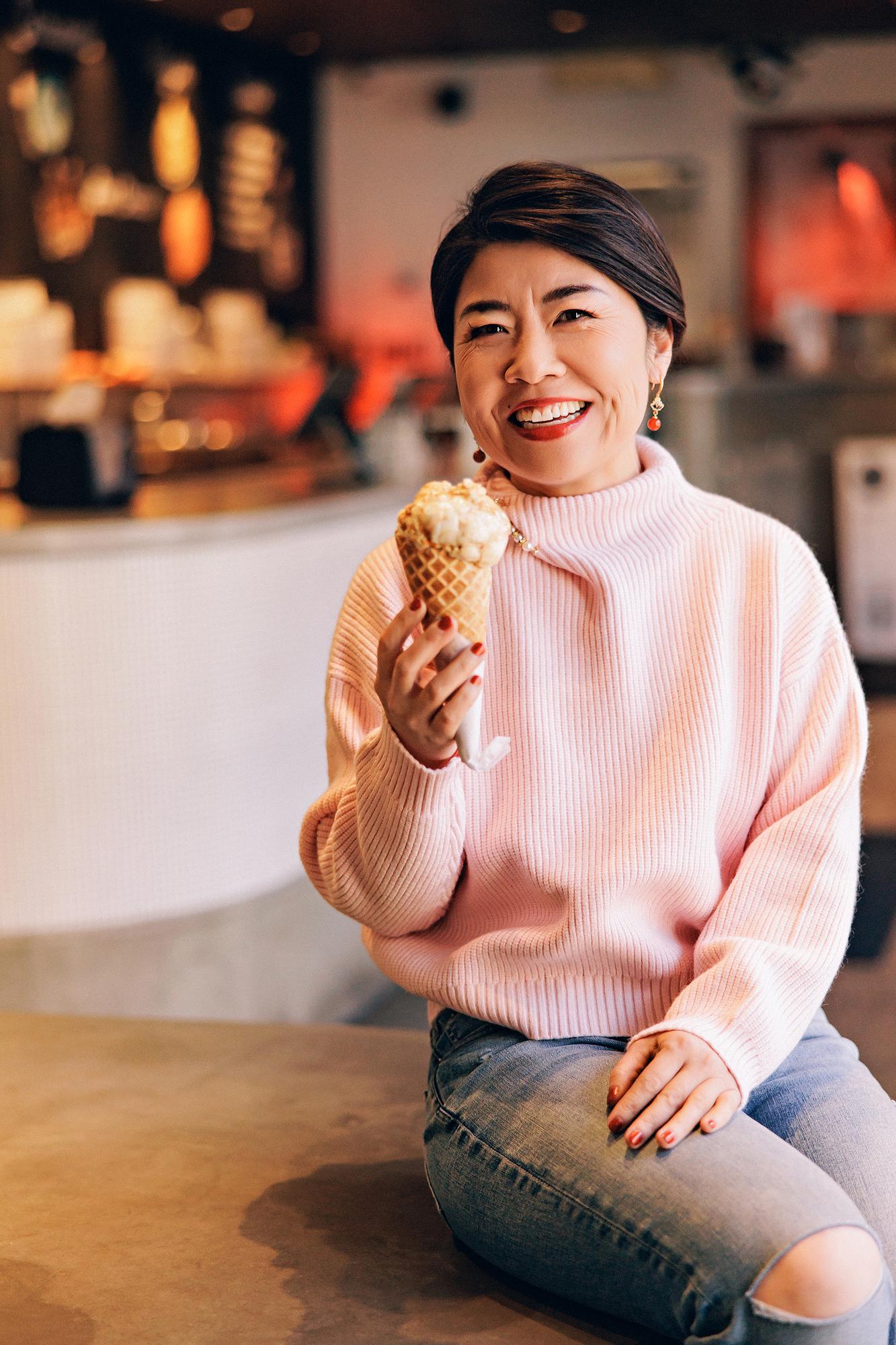 Personal Branding photography Calgary: Joyful moment sharing ice cream in a warmly lit Calgary cafe